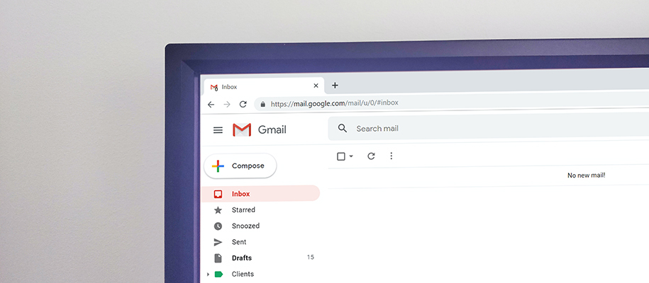 Corner of laptop open to a browser with an email inbox on screen