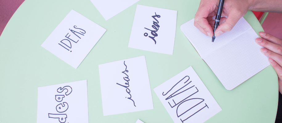 Handwritten notecards spread out on a table with the word "idea" written on each