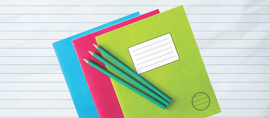 Three blue, pink, and green folders with three blue pencils against note paper