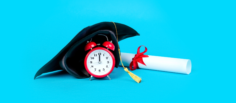 Black grad cap, red alarm clock, degree with red ribbon on sky blue backround