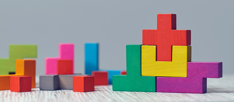 Colorful wood shapes, four stacked on top of each other to make a foundation