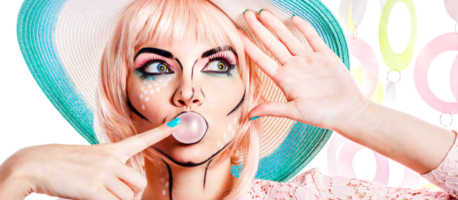 White female with Pop Art makeup and pink wig blowing bubble gum, pastel colors