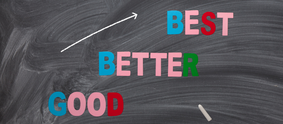 Good, Better, Best in colorful letters on erased blackboard with arrow and chalk