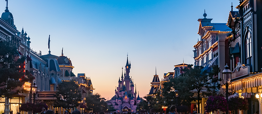 Wide-panned shot at dusk of Main Street in Disney World and Cinderella's castle