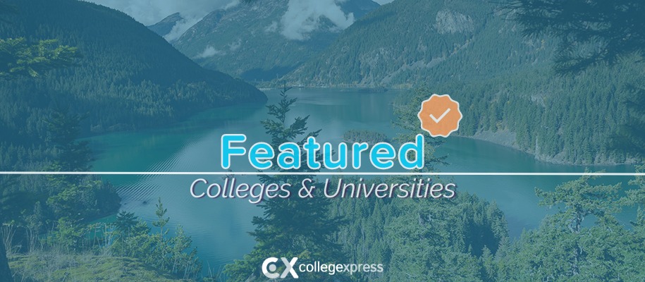 Greenish lake in Y-shape surrounded by trees & mountains, featured schools logo