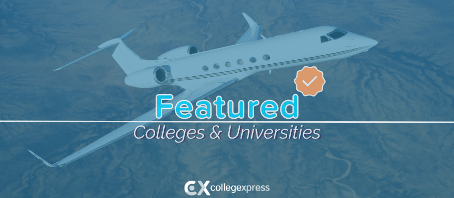 Small white commercial airplane flying over desert, featured schools logo