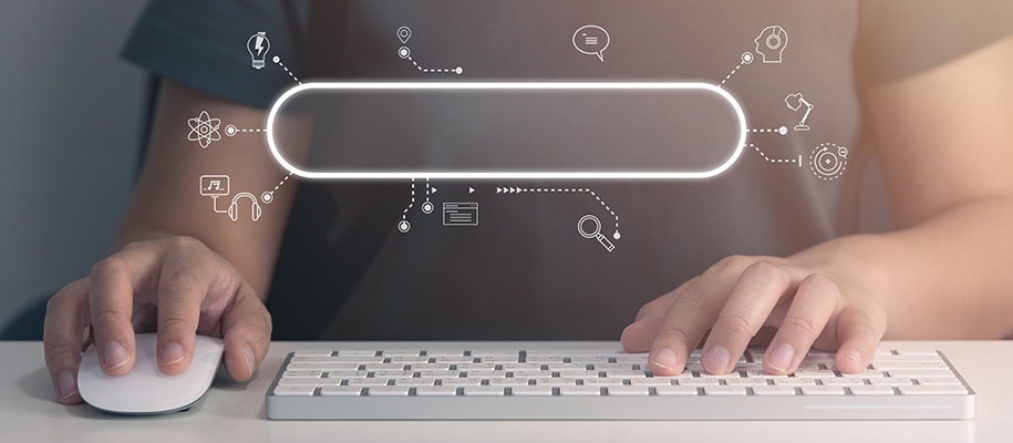 Body of person, hands on white mouse and keyboard, search bar with icons overlay