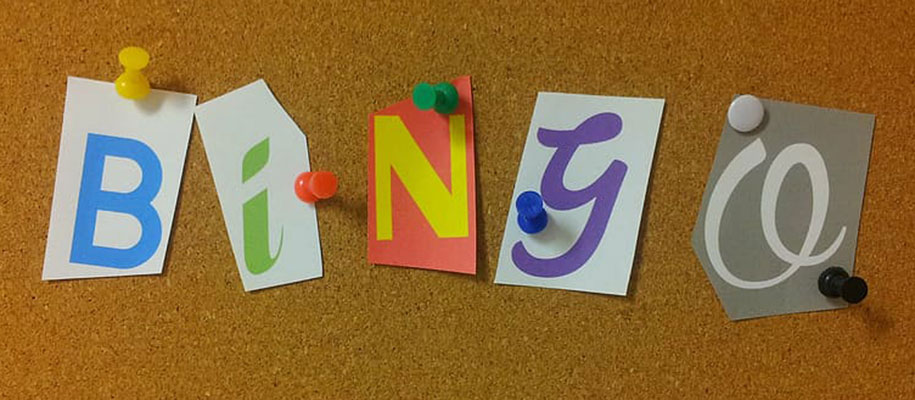 Letters cut from magazines that spell out Bingo tacked on corkboard