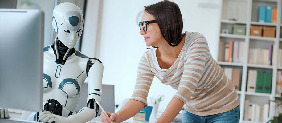 White woman in striped shirt and glasses looking at AI robot with blue eyes