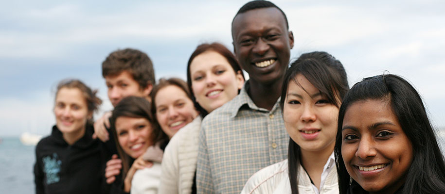 Group of smiling international students of different races in a slanted row