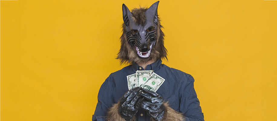 Person in werewolf mask and gloves holding fanned out cash