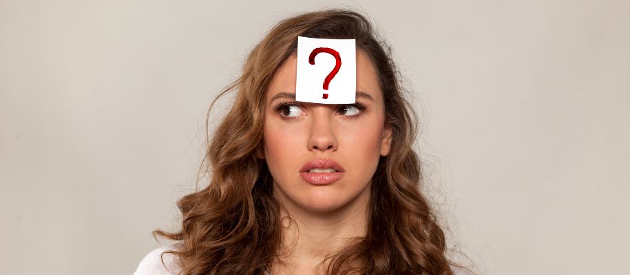 White woman looking confused, paper with question mark on forehead