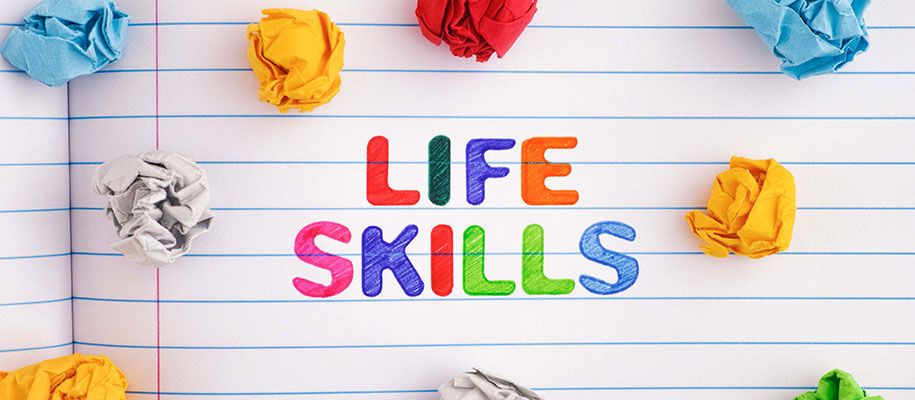 Life Skills written in colored markers in notebook with crumbled paper balls