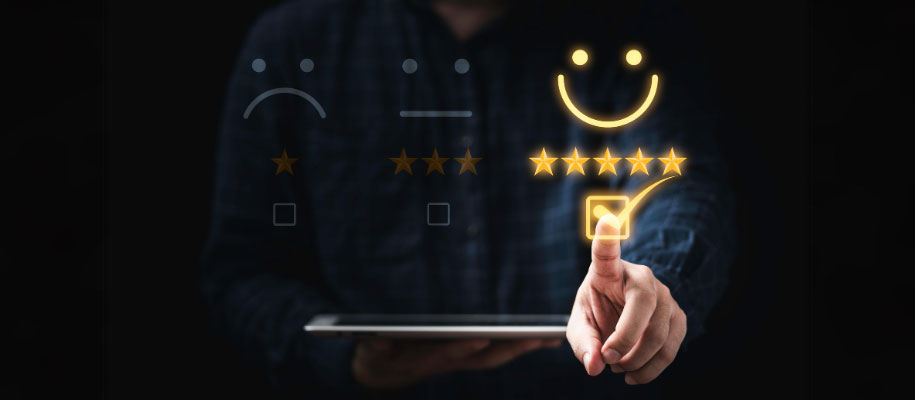 White person holding tablet, ticking checkbox next to happy face with five stars