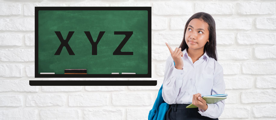 Young Indian female student thinking and pointing at blackboard reading X Y Z