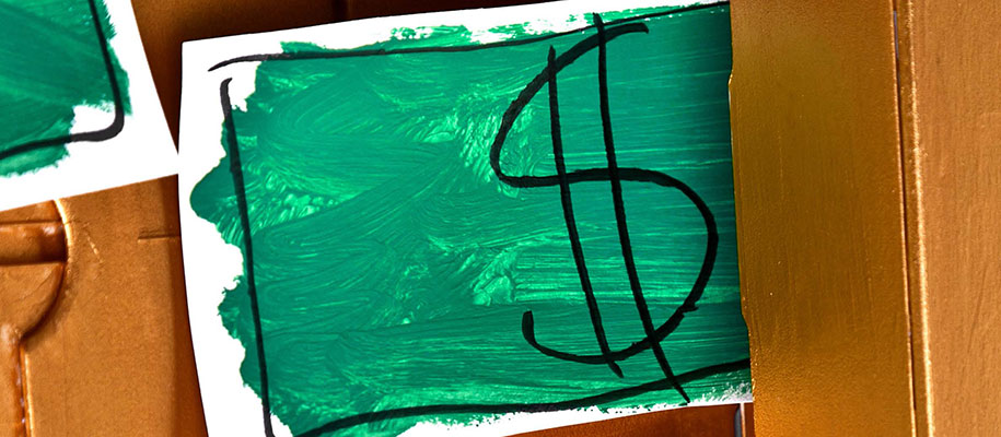 White poster board with crudely painted green rectangle and dollar sign