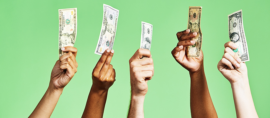 Five diverse hands holding up one, ten, 50, and 100 dollar bills
