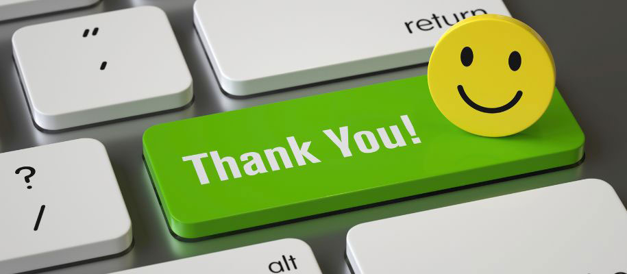 Apple keyboard with yellow smiley face and green button reading Thank You!