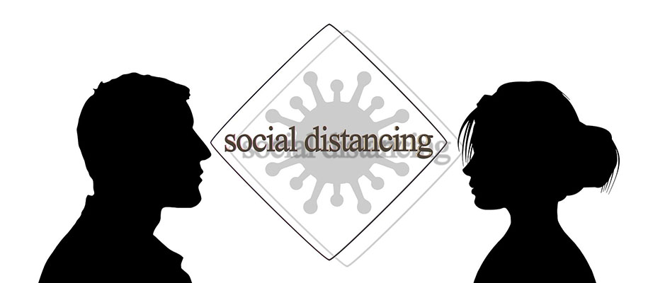 Silhouettes of man and woman separated by virus cell and the words social distan