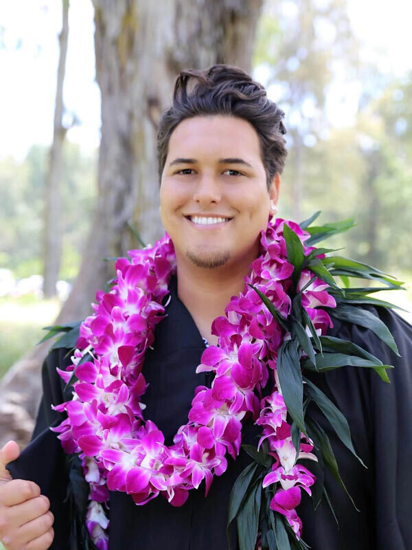 Hawaiian male graduate in black grad cap and lei