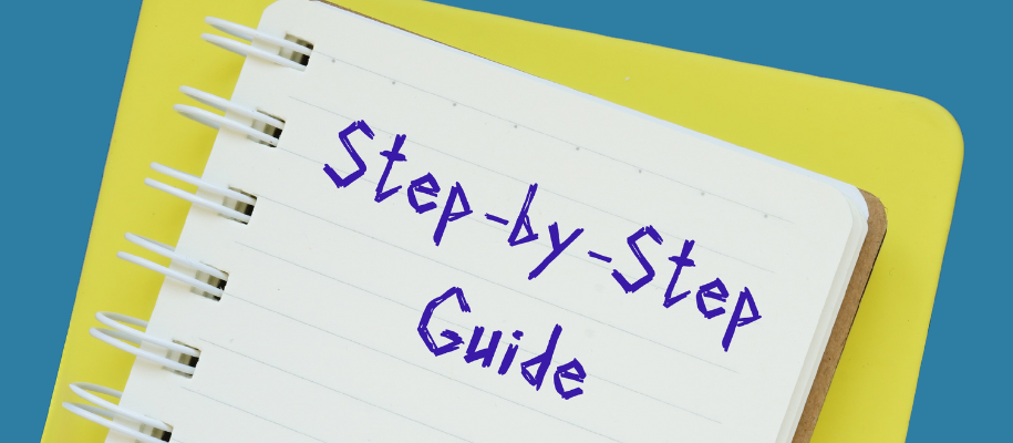 Yellow notebook with words Step-byStep Guide written on lined page in blue ink