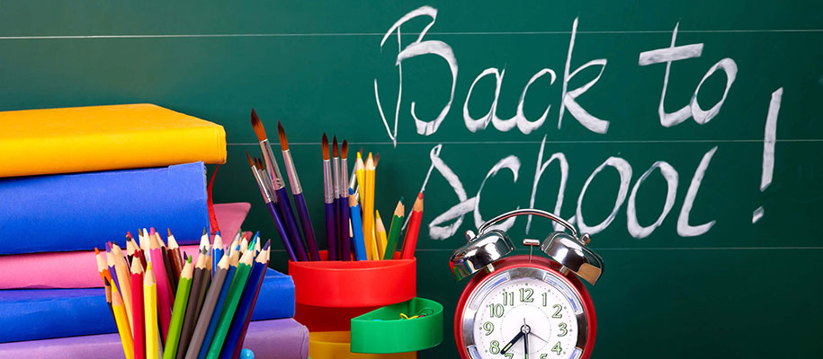 Back to School! written on chalkboard next to books, colored pencils, clock
