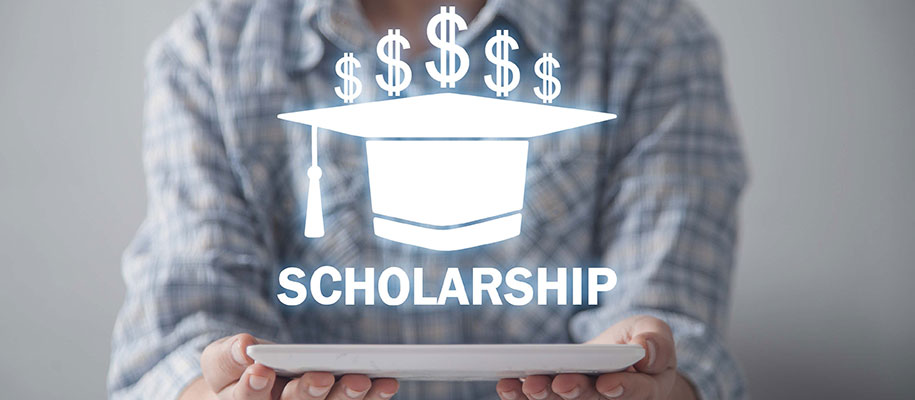 Person holding tablet below Scholarship & graduation cap, dollar sign graphics