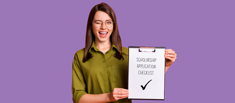 Winking woman in glasses holding paper reading Scholarship Application Checklist