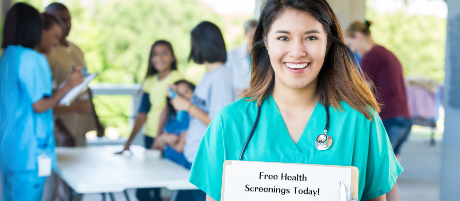 White brunette volunteer in scrubs at free health screening event in hospital