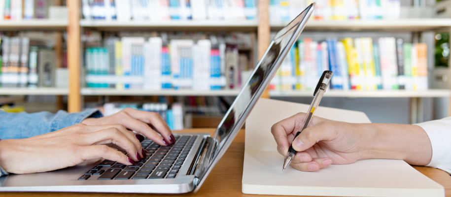 Wood table with hammer, pliers, wrench, screwdriver, and more tools organized