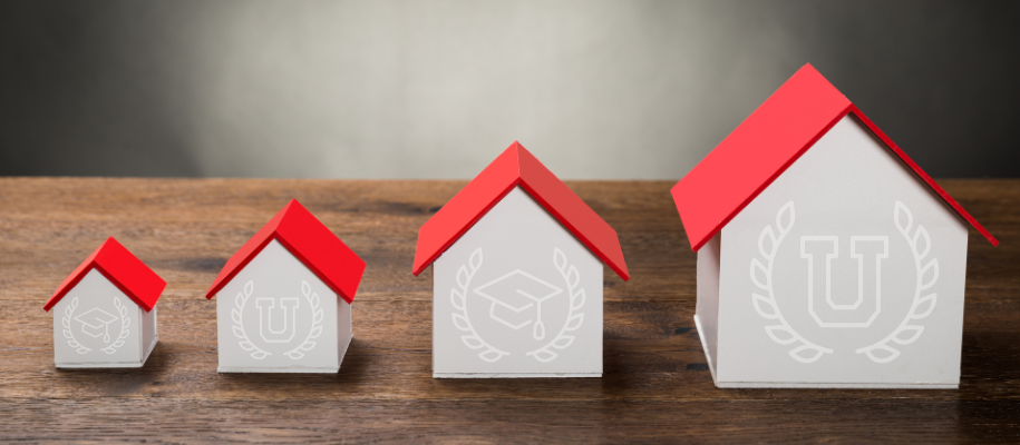 Little white houses with red roofs of varying sizes and white college icons