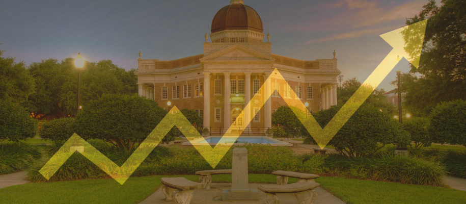 Picturesque college campus with yellow trend arrow overlayed on top
