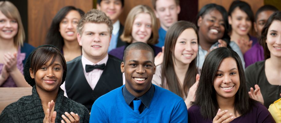 Group of diverse students dressed nicely in church pews