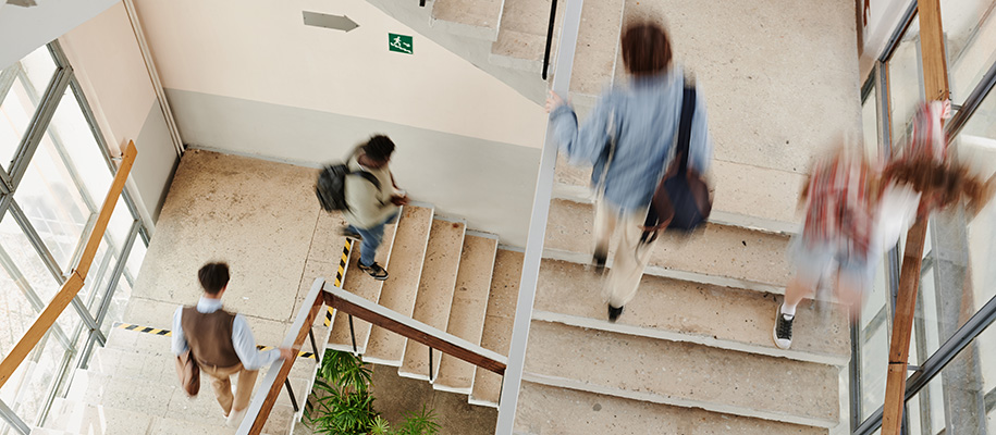 People walking fast up and down well-lit stairway