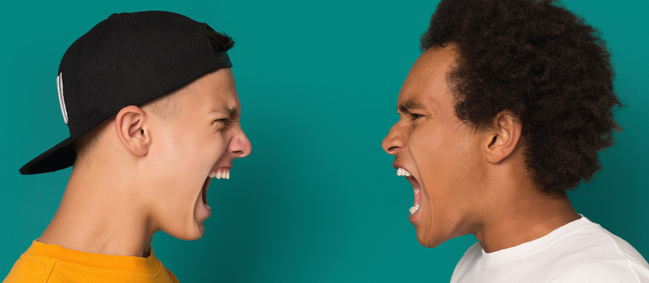 White male in backwards cap and Black male with curly hair yelling at each other