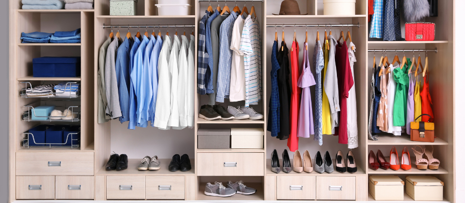 Wall-length built-in wardrobe with men’s and women’s clothes and shoes
