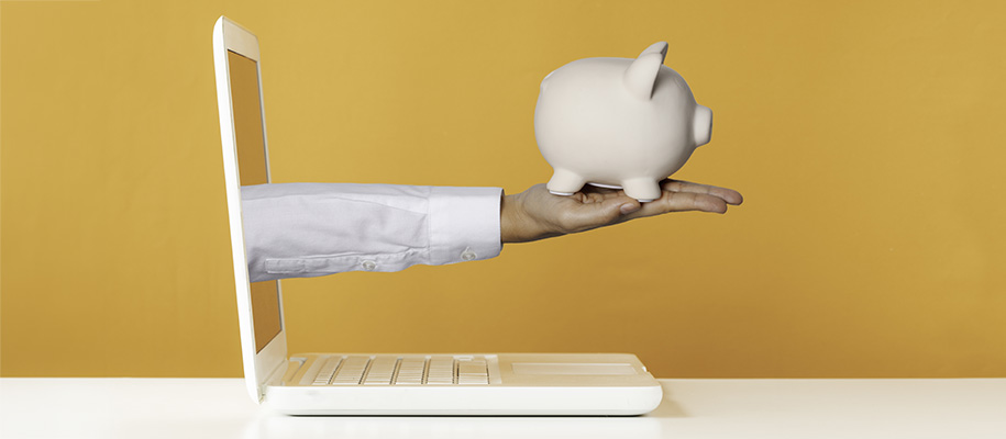 Arm in white shirt sticking out of laptop screen, piggy bank in palm