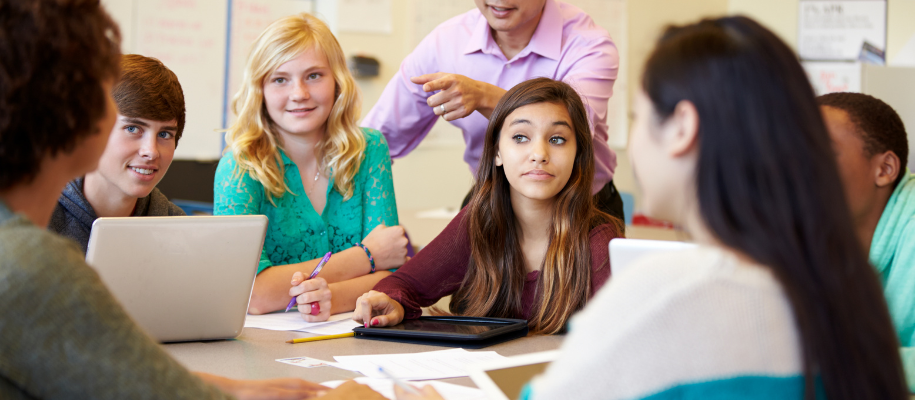 Big group of racially and gender diverse students, many with cameras around neck