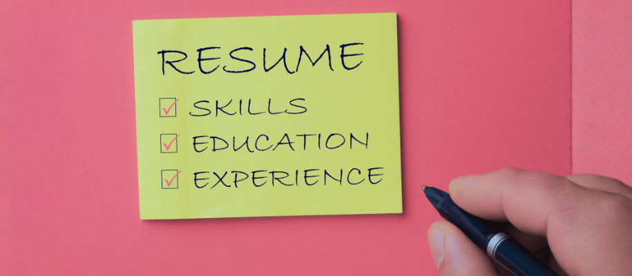 Sticky note titled Resume with checkmarks on skills, education, experience