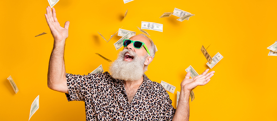 Older man with white bear in sunglasses and leopard shirt, money falling around