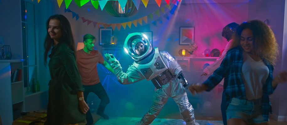 Man in astronaut costume dancing at party with no on else in costume