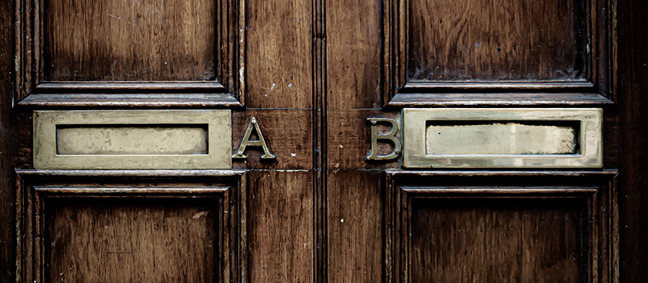 Wooden door with brass mail slots reading A and B next to each