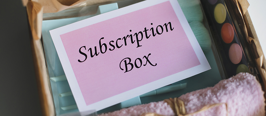 Subscription care box with pink towel, makeup, makeup brushes